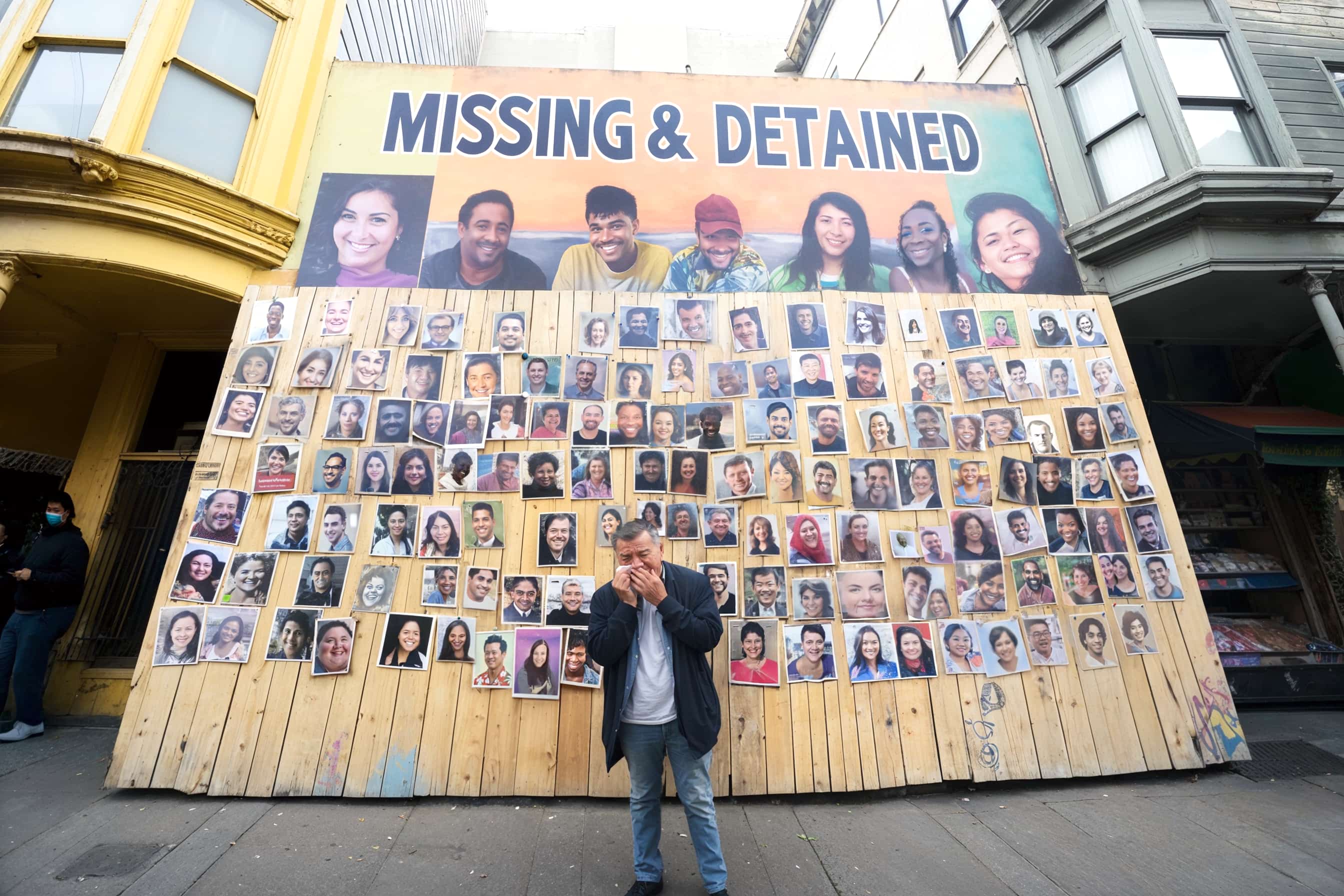 Man adds photo to wall of detained protesters